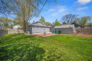 Back of property with a lawn, central AC, a patio, and a fenced backyard