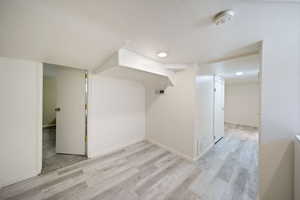 Bonus room featuring recessed lighting, light wood-style flooring, visible vents, and baseboards