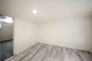 Spare room featuring recessed lighting, light wood-style floors, visible vents, and baseboards