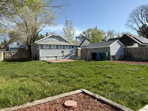 View of yard featuring cooling unit, a patio area, a shed, and a fenced backyard