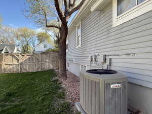 Details featuring central air condition unit and fence
