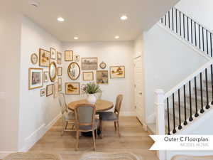 Dining area with recessed lighting, light wood-style flooring, baseboards, and stairway