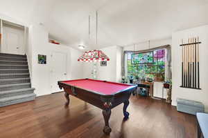 Game room featuring vaulted ceiling, dark wood-type flooring, pool table, and baseboards