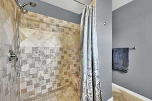 Bathroom featuring tiled shower