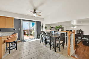 Dining area featuring a ceiling fan and vaulted ceiling