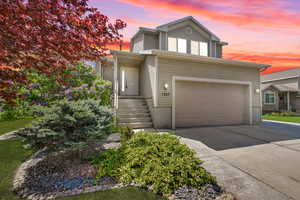 Traditional-style house with an attached garage and driveway
