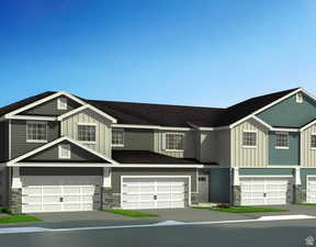 View of front of home with board and batten siding, an attached garage, stone siding, and concrete driveway