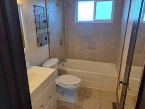 Full bathroom featuring vanity, washtub / shower combination, toilet, tile patterned flooring, and visible vents