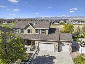 Traditional-style house with fence private yard, concrete driveway, stucco siding, and a mountain view