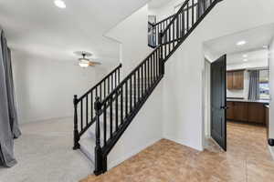 Stairs featuring baseboards, a ceiling fan, and recessed lighting