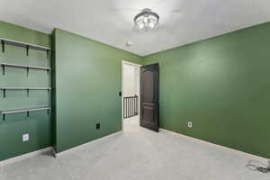 Unfurnished bedroom featuring baseboards and carpet