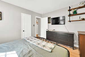 Bedroom featuring wood finished floors and baseboards