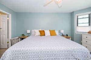 Bedroom with ceiling fan and carpet flooring