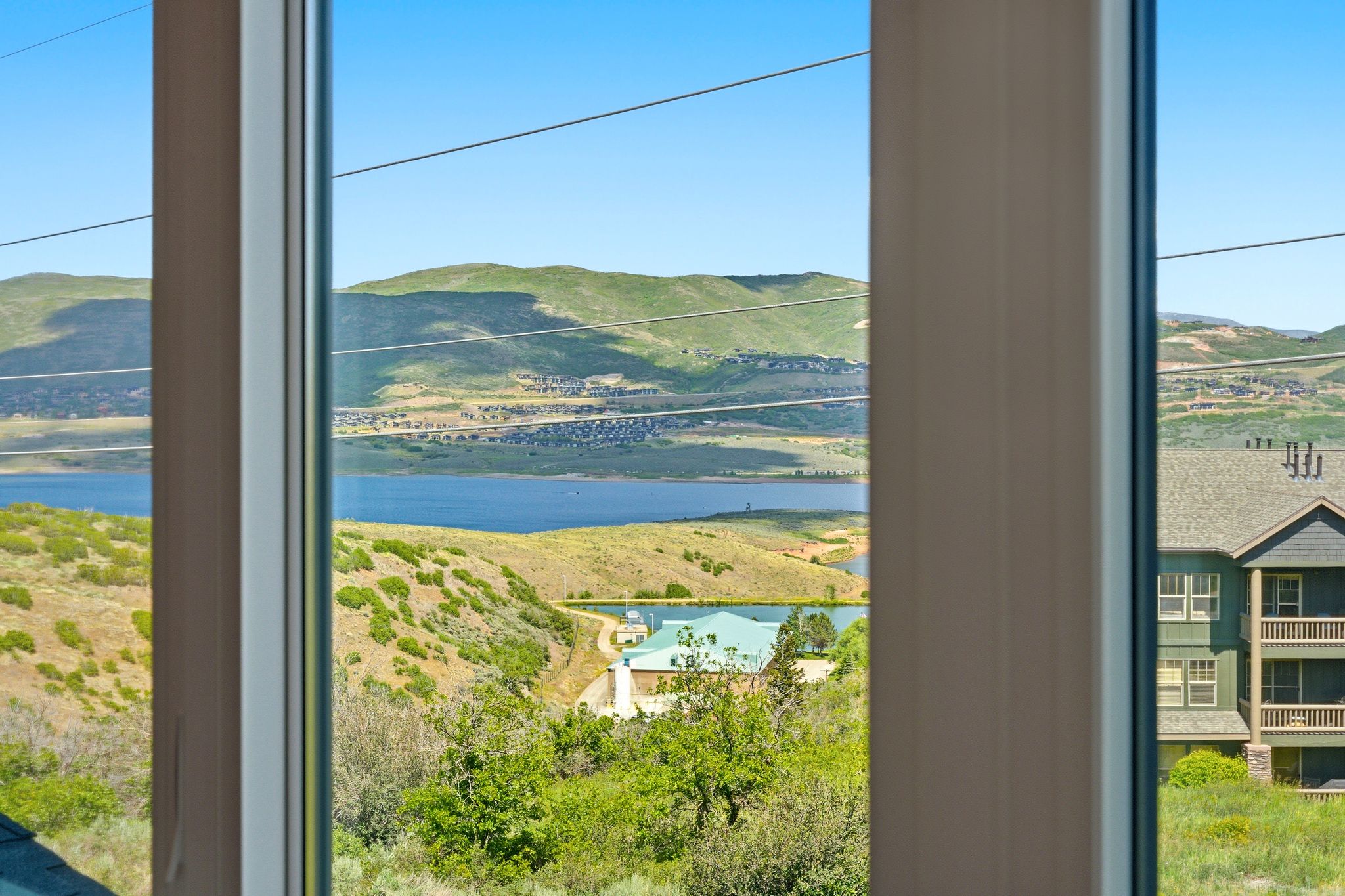 Expansive lake and mountain scenery framed by window casements