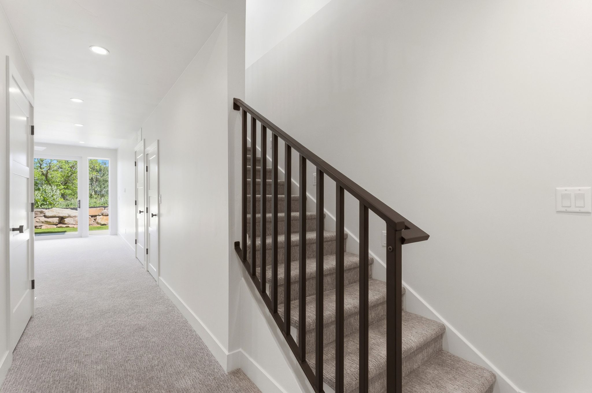 Carpeted staircase with contemporary metal railing