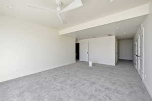 Empty room featuring light colored carpet, recessed lighting, and ceiling fan
