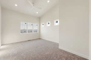 Carpeted empty room with a ceiling fan and recessed lighting