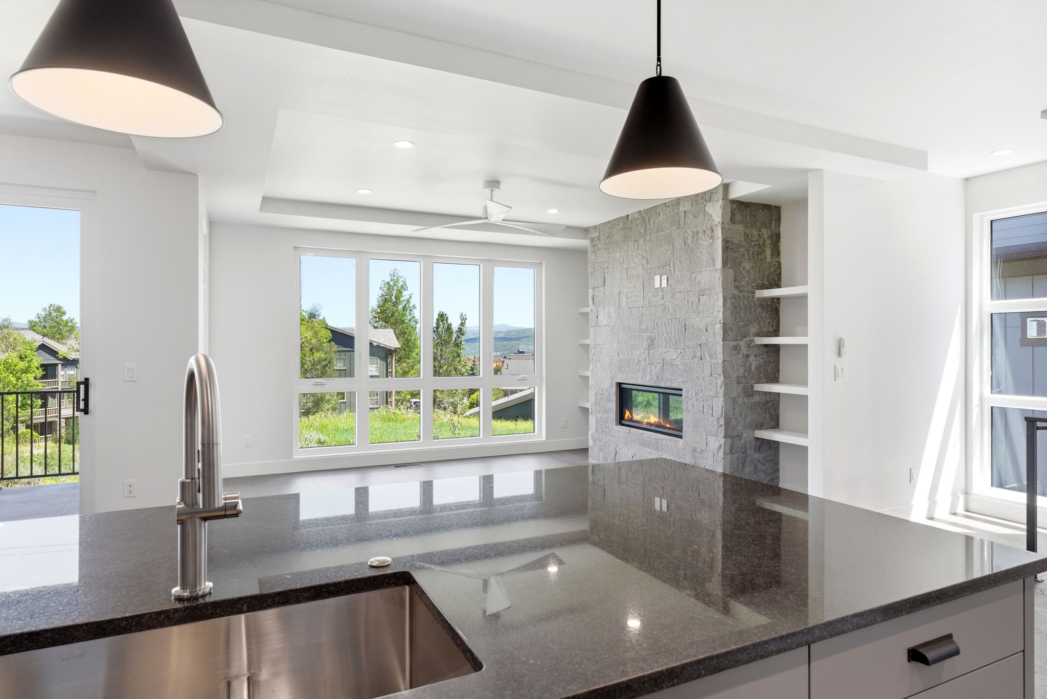 Kitchen island with a stainless steel undermount sink and a gooseneck faucet