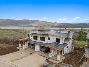 View of front of home featuring a water and mountain view