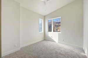 Carpeted spare room with baseboards