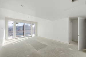 Spare room featuring unfinished concrete flooring