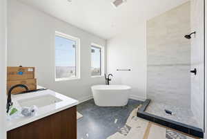 Bathroom with vanity, a tile shower, and a freestanding tub