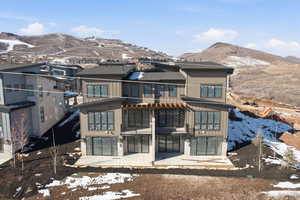View of front of home with a mountain view, a patio, a pergola, and board and batten siding