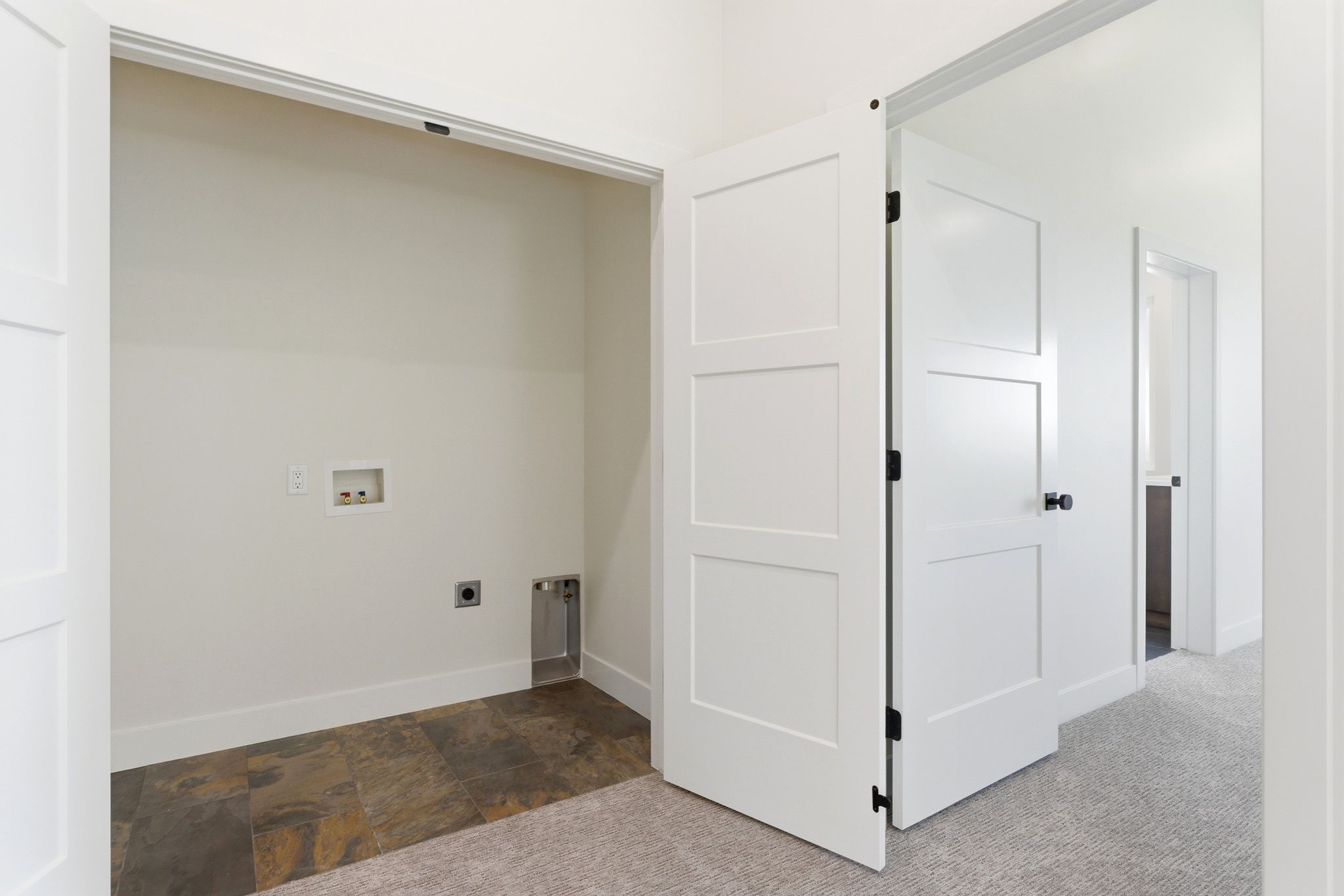 Dedicated laundry closet featuring a tile floor, white walls, and hookups for appliances