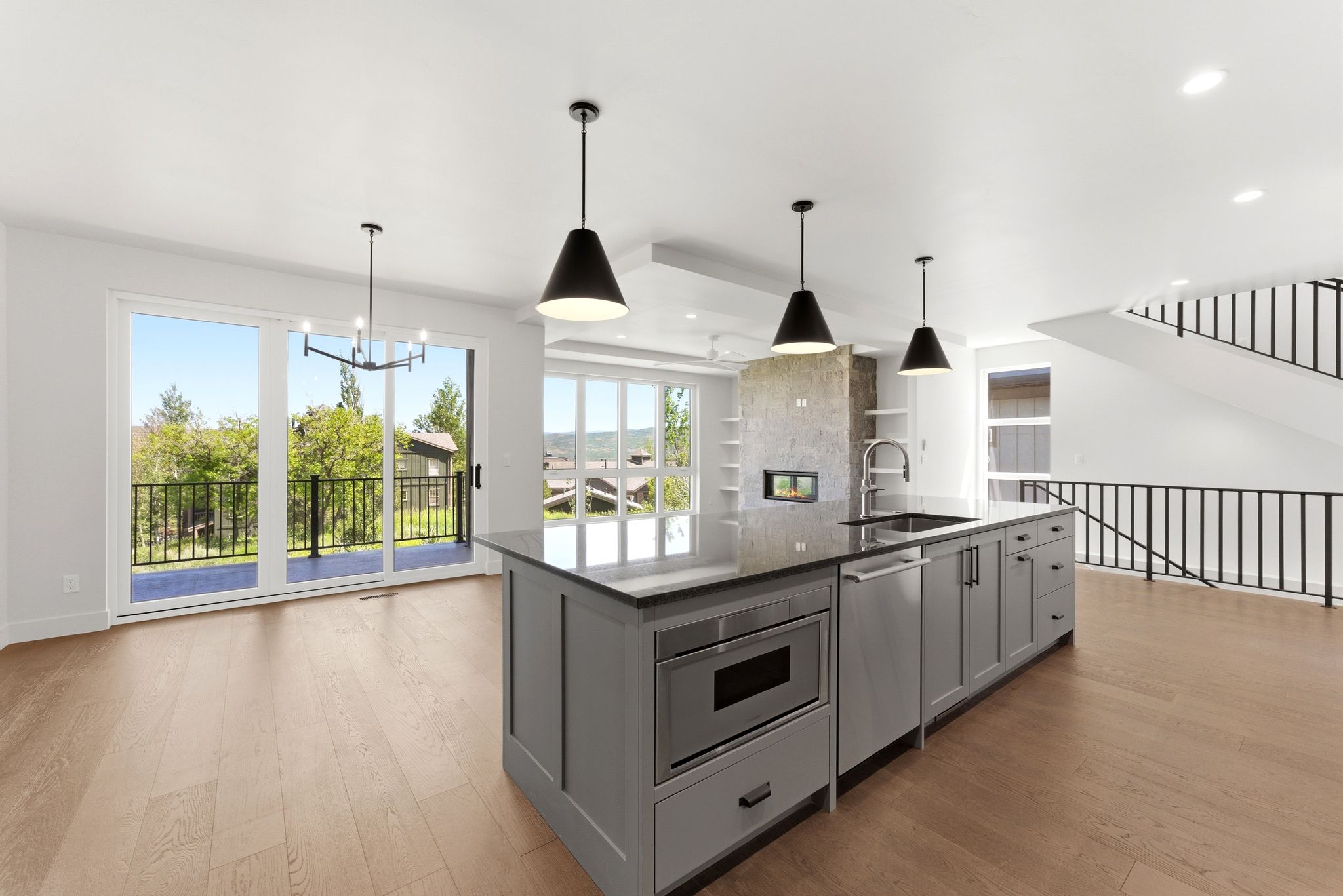 Modern kitchen island with integrated stainless steel microwave, undermount sink, and dishwasher