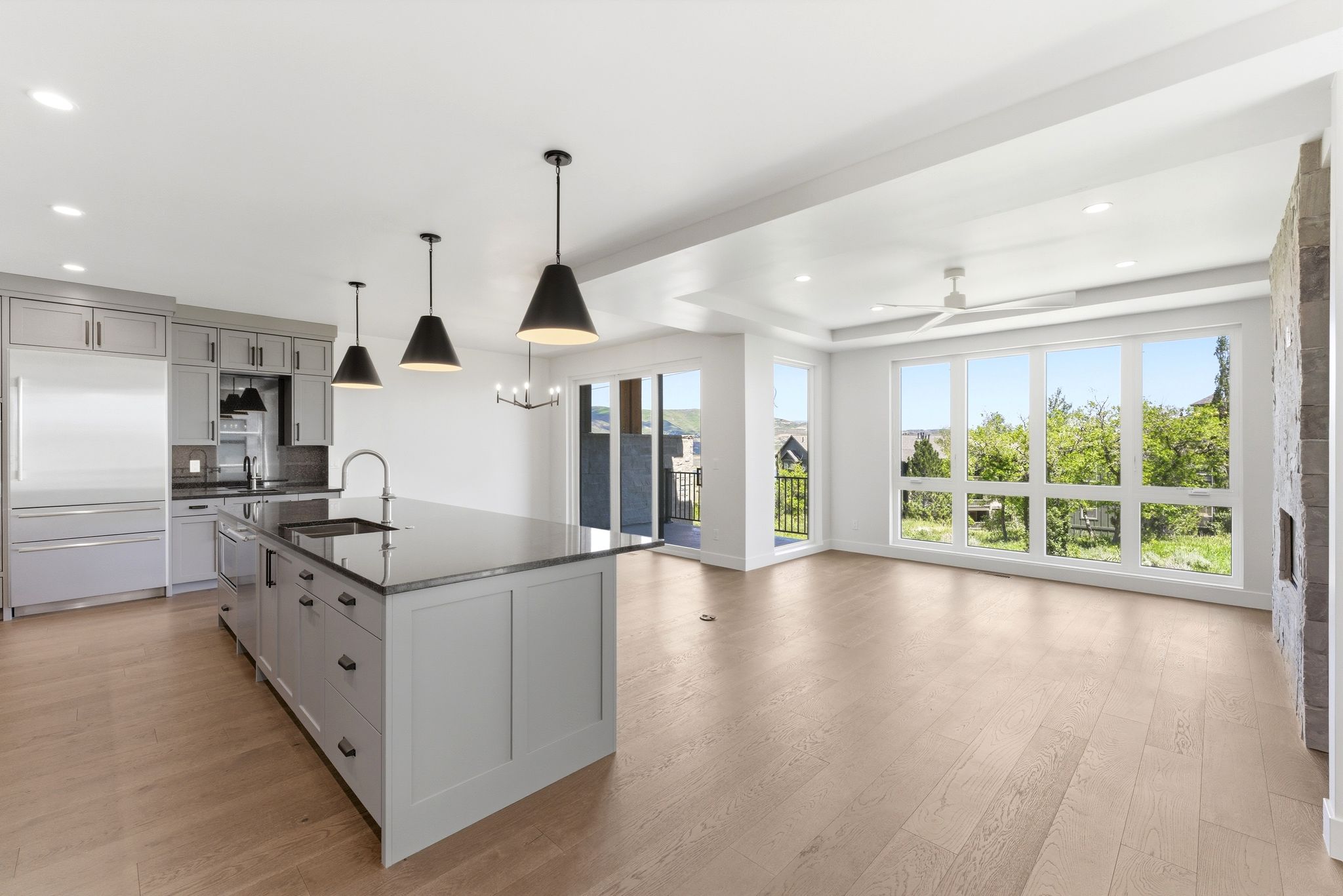 Open-concept living space with light wood-finish flooring