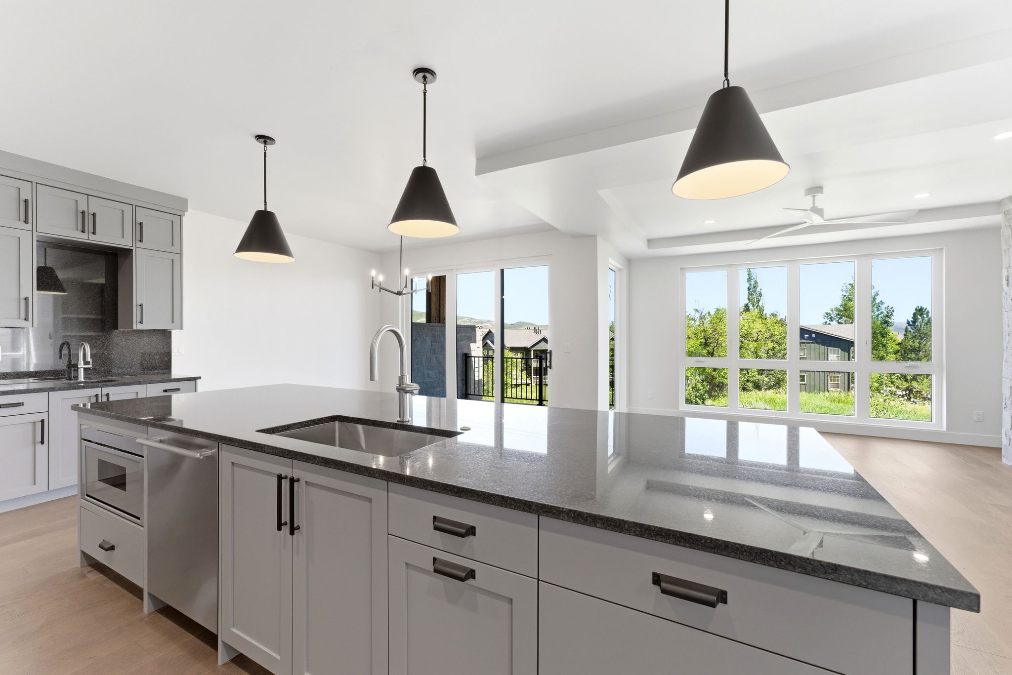 Expansive kitchen island featuring a built-in stainless steel sink and under-counter microwave