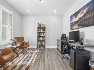 Home office with baseboards, wood finished floors, and recessed lighting