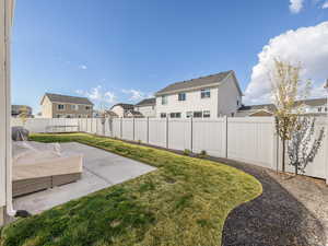View of yard featuring a patio area, a residential view, and a fenced backyard