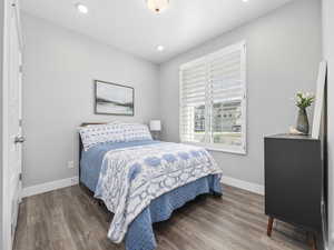 Bedroom featuring wood finished floors, baseboards, and recessed lighting