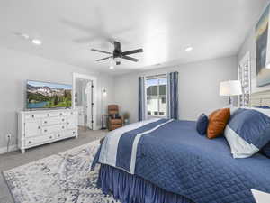 Bedroom with light carpet, ensuite bathroom, baseboards, recessed lighting, and ceiling fan