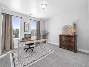 Carpeted office featuring baseboards and visible vents