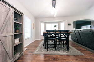 Dining area with lots of room for family and guests.  LVT floors, arched walkways, and a healthy amount of sunlight
