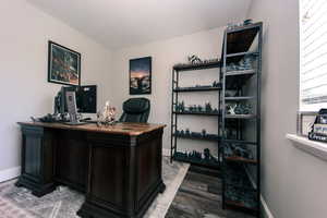 #3 The bedroom/office area has wood-finished floors and a view of the backyard with pretty spring-flowering trees!