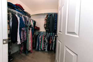 View of walk-in closet with plenty of room for all your favorites!