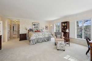 Carpeted bedroom with ornamental molding