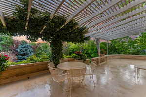 View of patio / terrace featuring a pergola and outdoor dining space