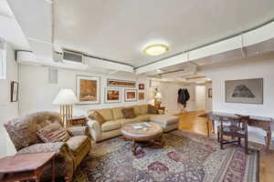Living room with wood finished floors and visible vents