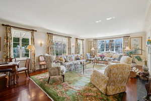 Living room with crown molding and wood finished floors