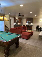 Playroom featuring carpet flooring, baseboards, recessed lighting, a wall mounted air conditioner, and a ceiling fan