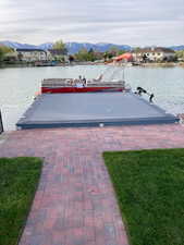 View of dock featuring a water and mountain view