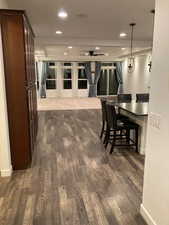 Interior space with baseboards, recessed lighting, and dark wood-style floors