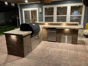 View of patio / terrace with grilling area, a ceiling fan, and area for grilling
