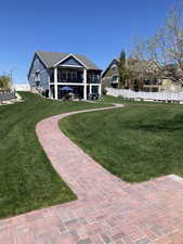 Back of house with fence and a yard