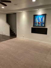 Family room with stairway, ceiling fan, carpet floors, baseboards, and recessed lighting