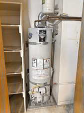 Utility room featuring secured water heater